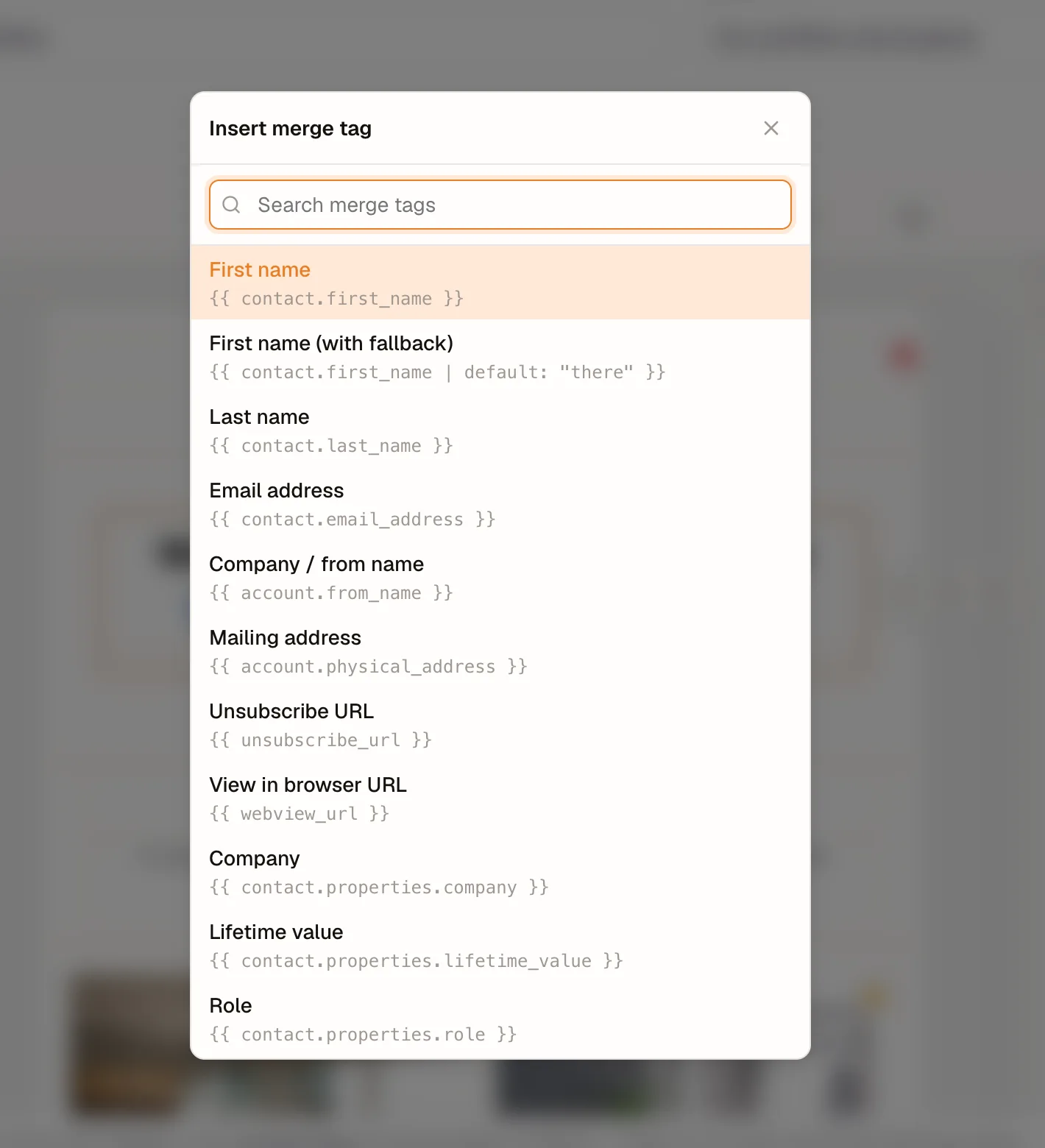 The Insert merge tag menu open over a text block, listing each tag with its literal, such as First name and its double-brace contact.first_name tag.